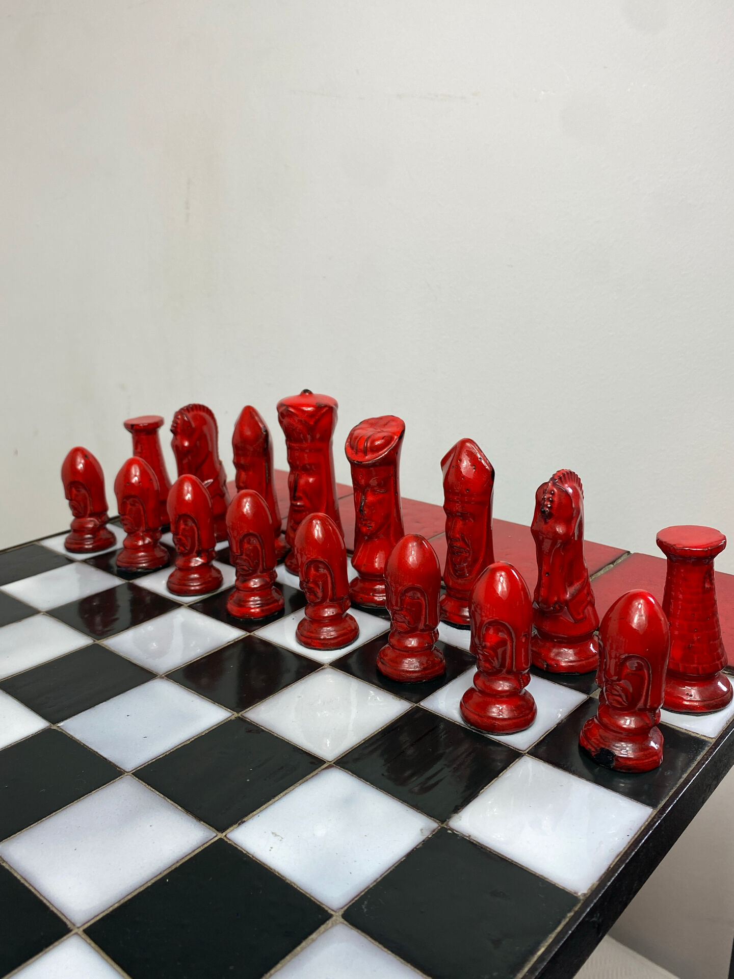 Chess set with ceramic board and pieces.
