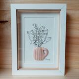 Composition of a bouquet of lily of the valley in a clay mug