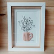 Composition of a bouquet of lily of the valley in a clay mug