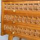 Vintage wooden and rattan chest of drawers with tapered legs.