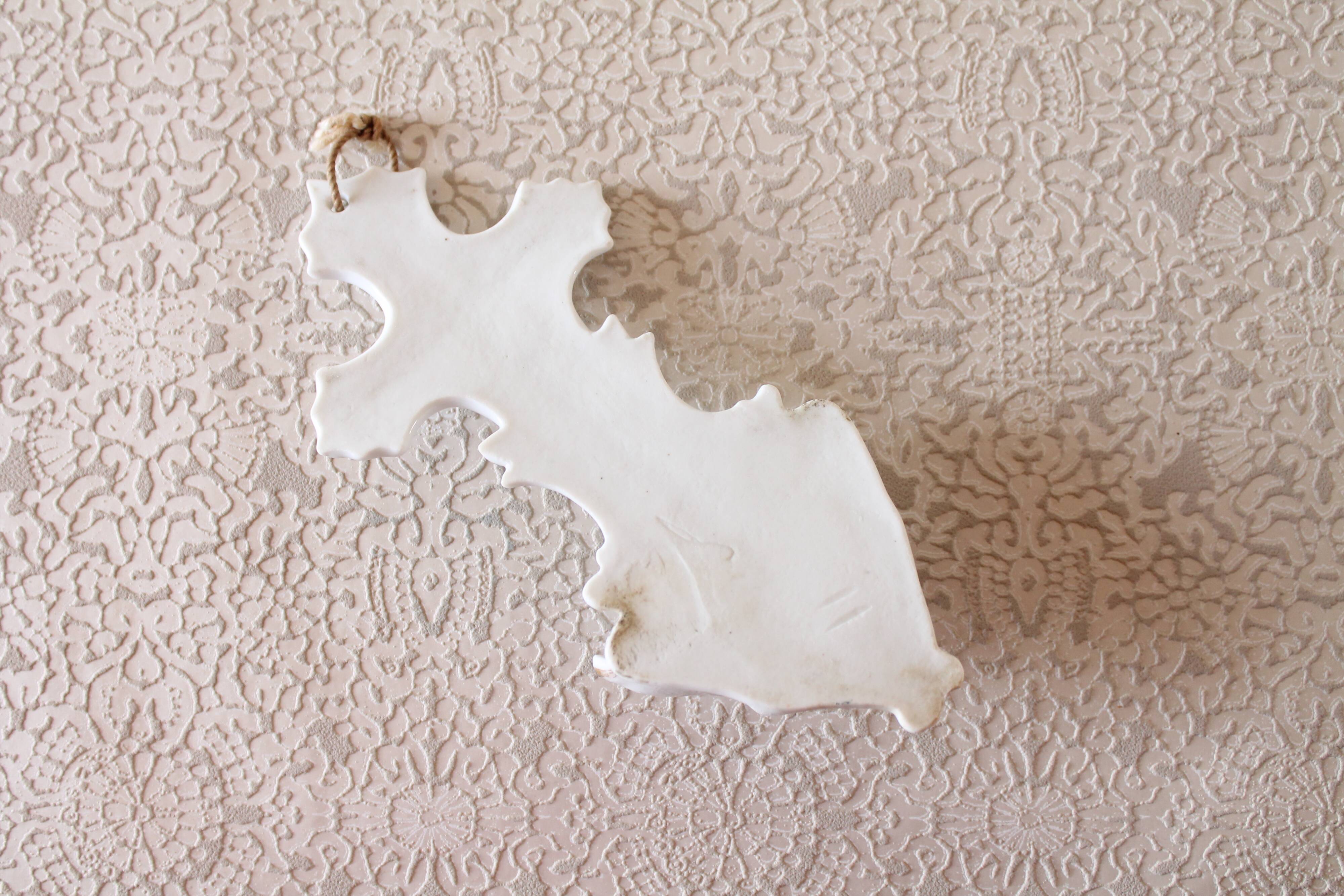 Antique holy water font in white porcelain biscuit.