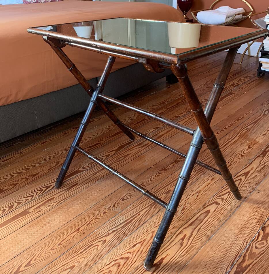 Folding mahogany table with a mirror top.