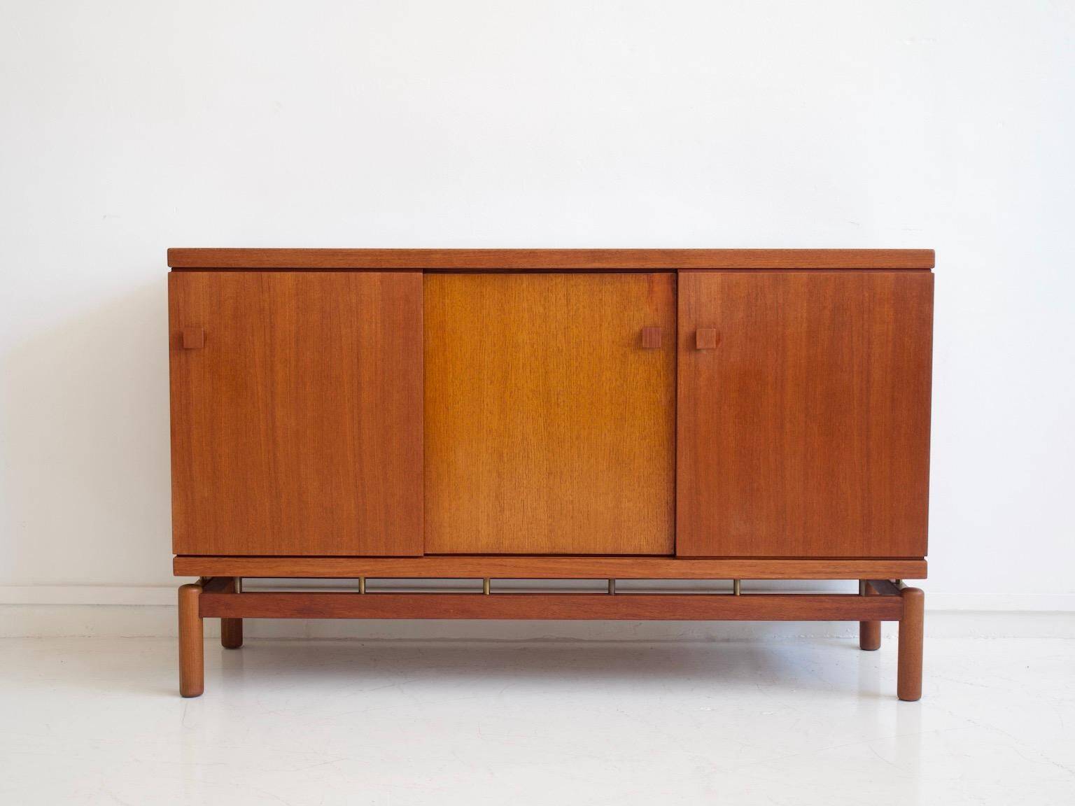 Modern mid-century teak sideboard with brass details.