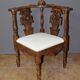 19th century walnut corner armchair with carved angel decoration