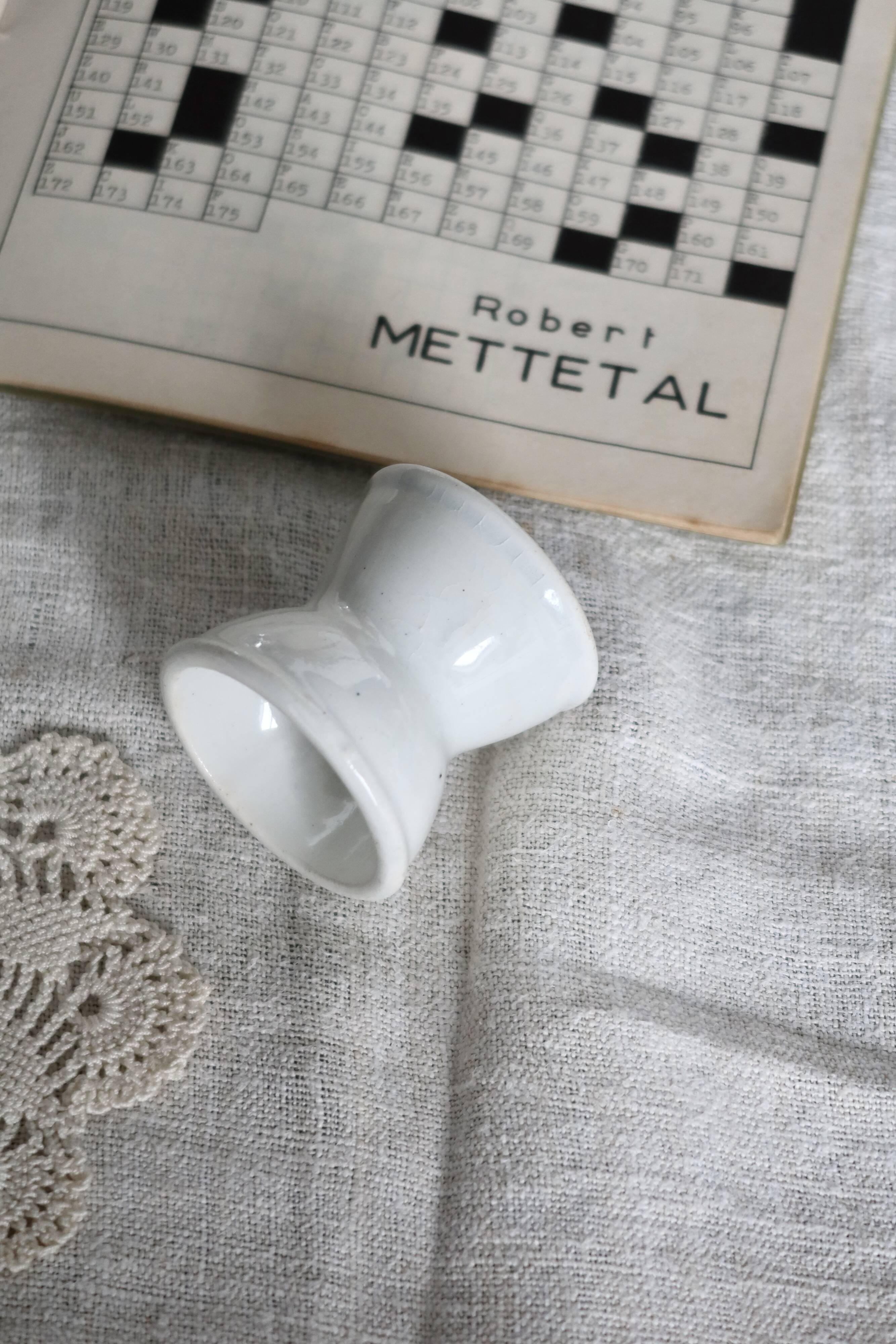 Antique diabolo egg cup in white earthenware