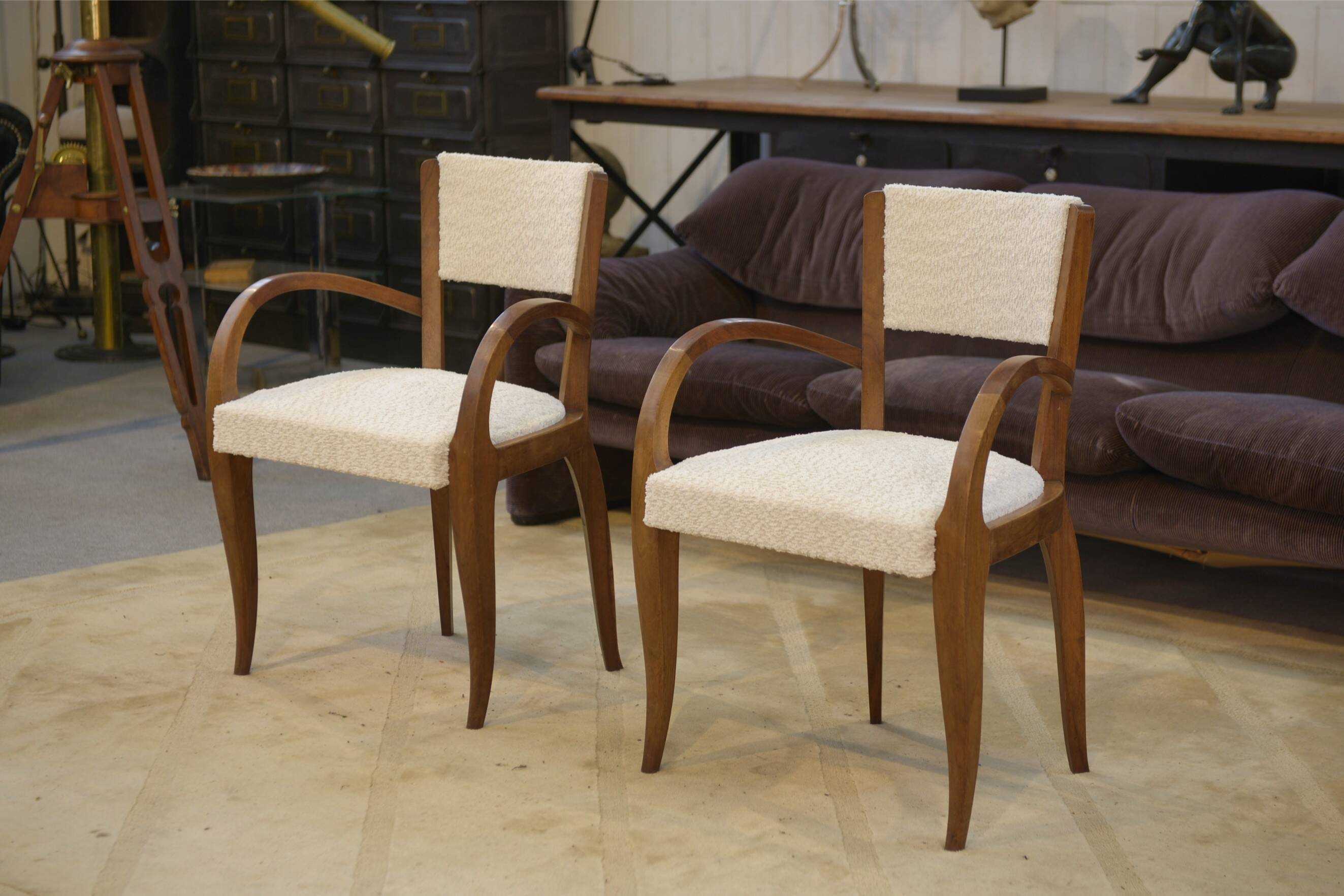Pair of bridge armchairs in walnut and cream boucle fabric, early 20th century.