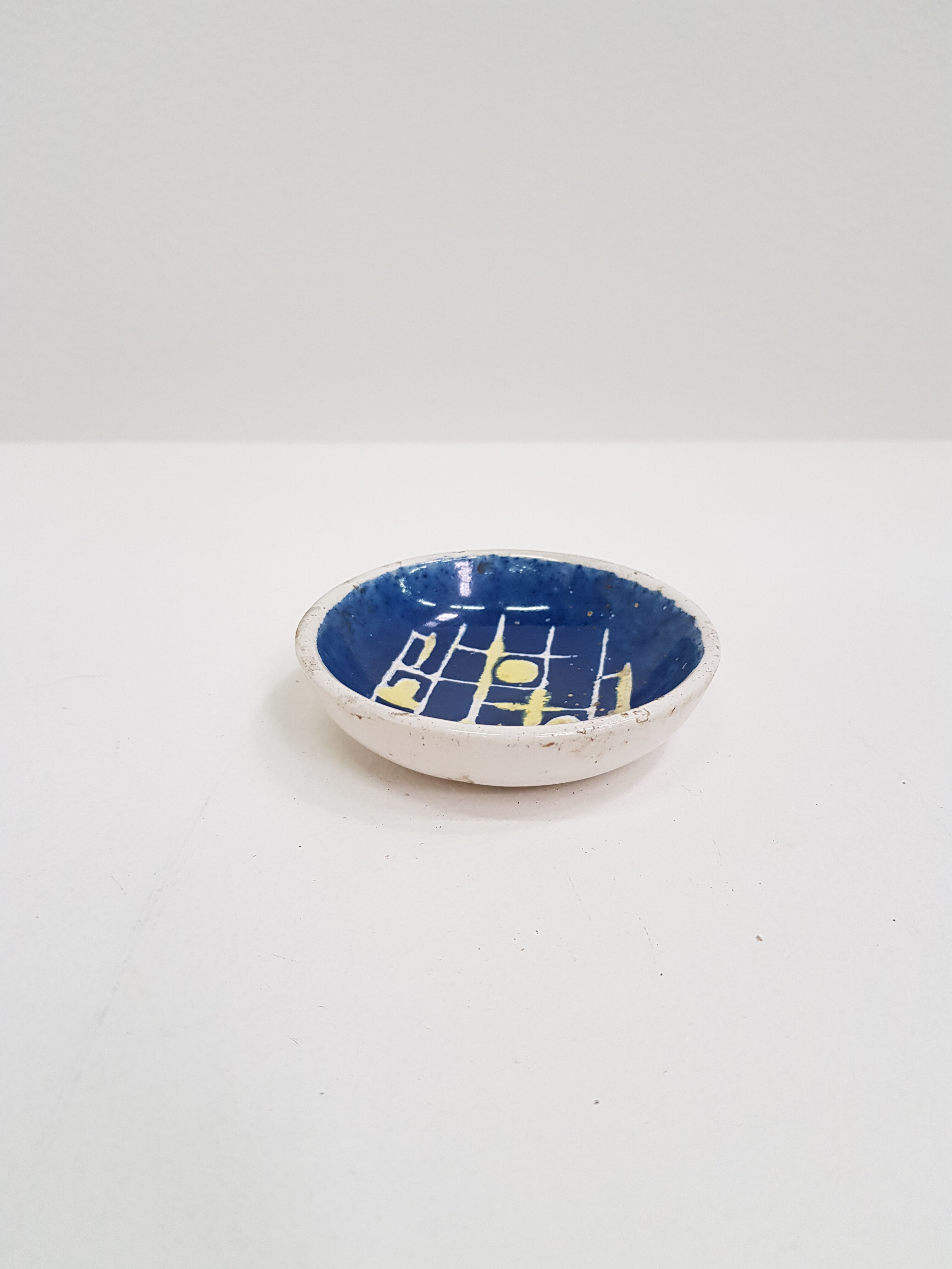 Small cup in white and blue vintage ceramic with yellow motis.