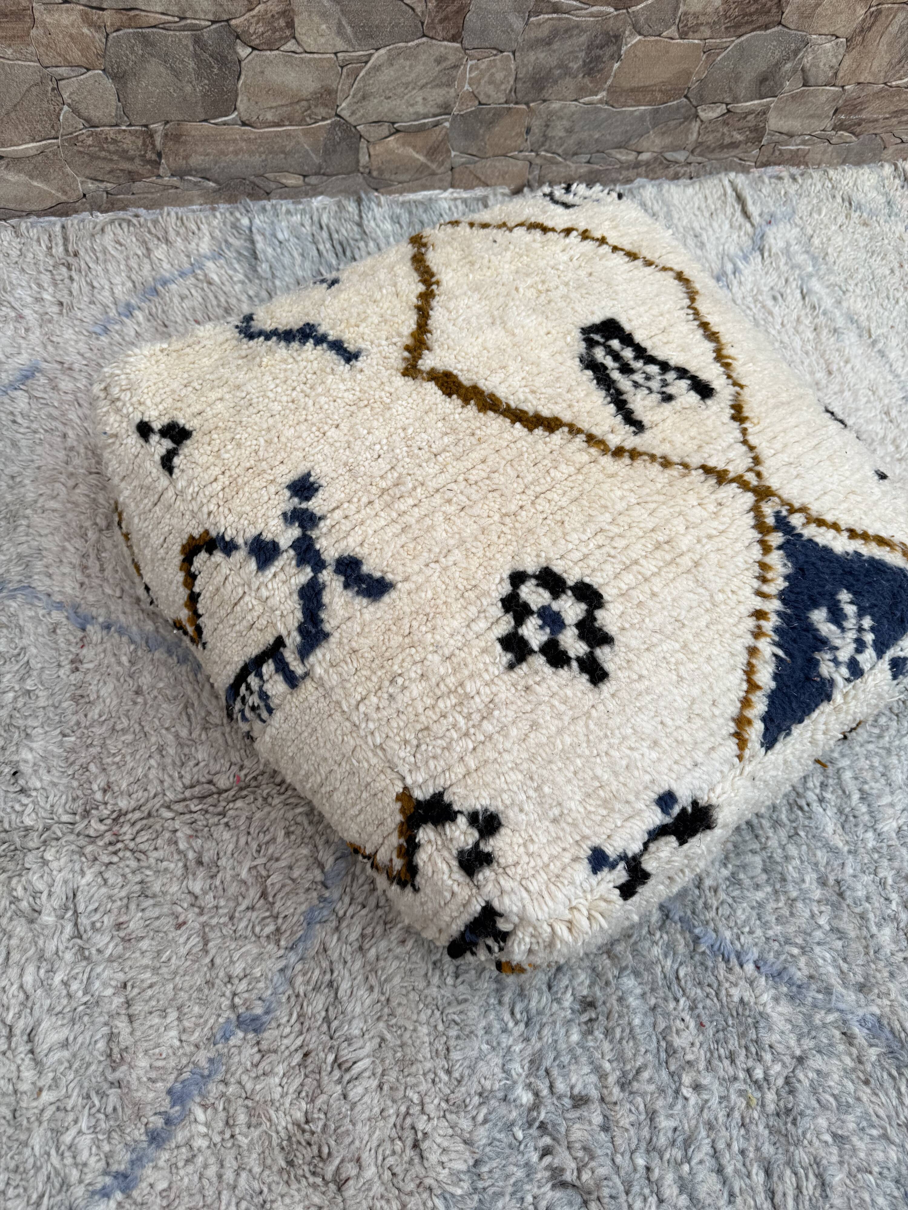 Berber floor pouf: Handwoven Moroccan wool cushion.