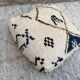 Berber floor pouf: Handwoven Moroccan wool cushion.