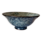 Bowl on a circular base or small blue ceramic dish.