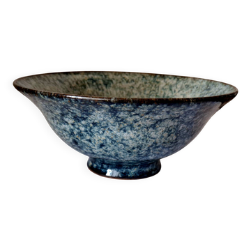 Bowl on a circular base or small blue ceramic dish.