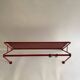 Vintage perforated red metal shelf