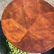 Art Deco side table in brown walnut, round top and scroll legs, France 1930s.