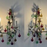 Lustrous chandelier with two wall lights decorated with foliage and pendants.