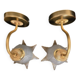 Frosted glass wall sconces and gilded brass in Art Deco style.