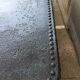 large industrial table in graphite black riveted metal