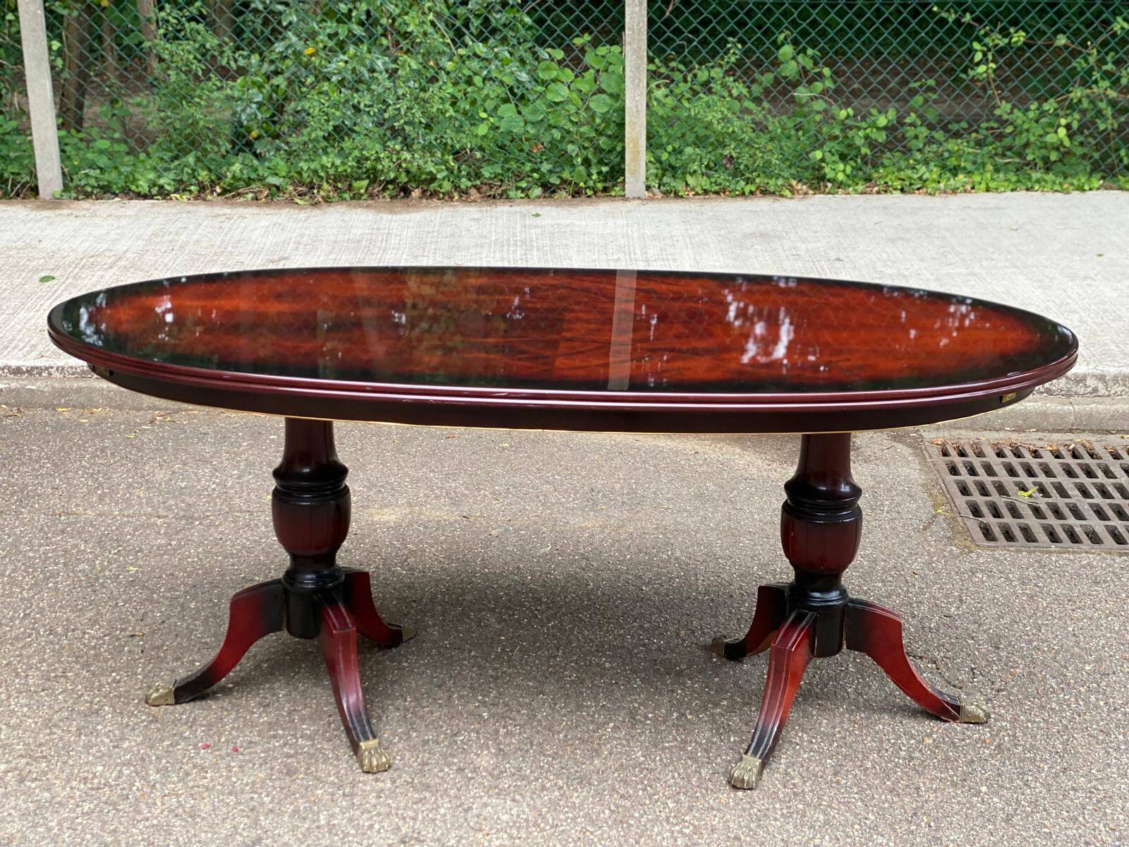 Glossy mahogany dining table in English Regency style from the 1970s.