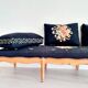 Old bench upholstered in black canvas flowers