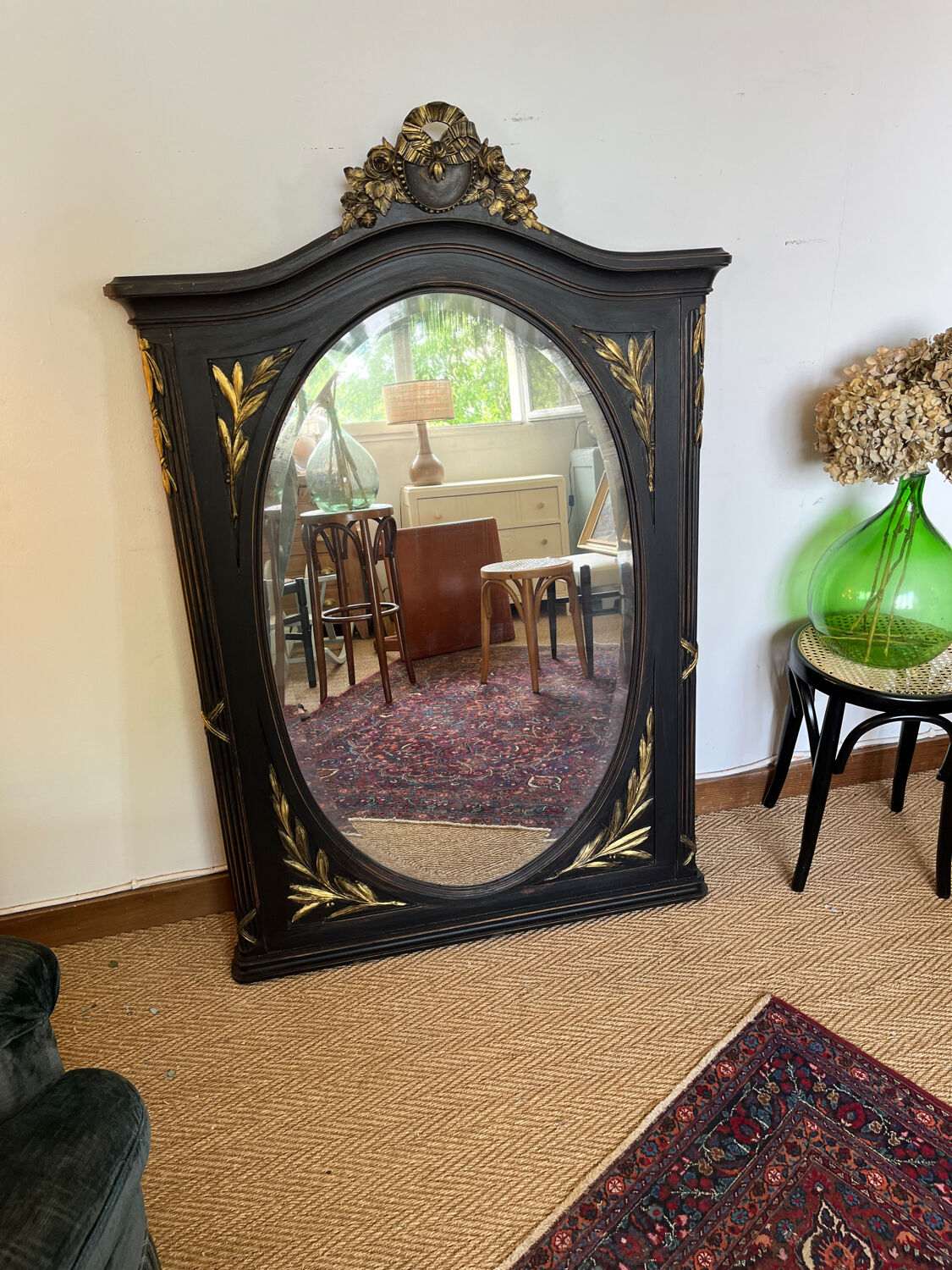 Large old trumeau mirror in black and gilded wood Napoleon style