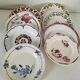 Set of 8 ironstone plates with coordinated designs.