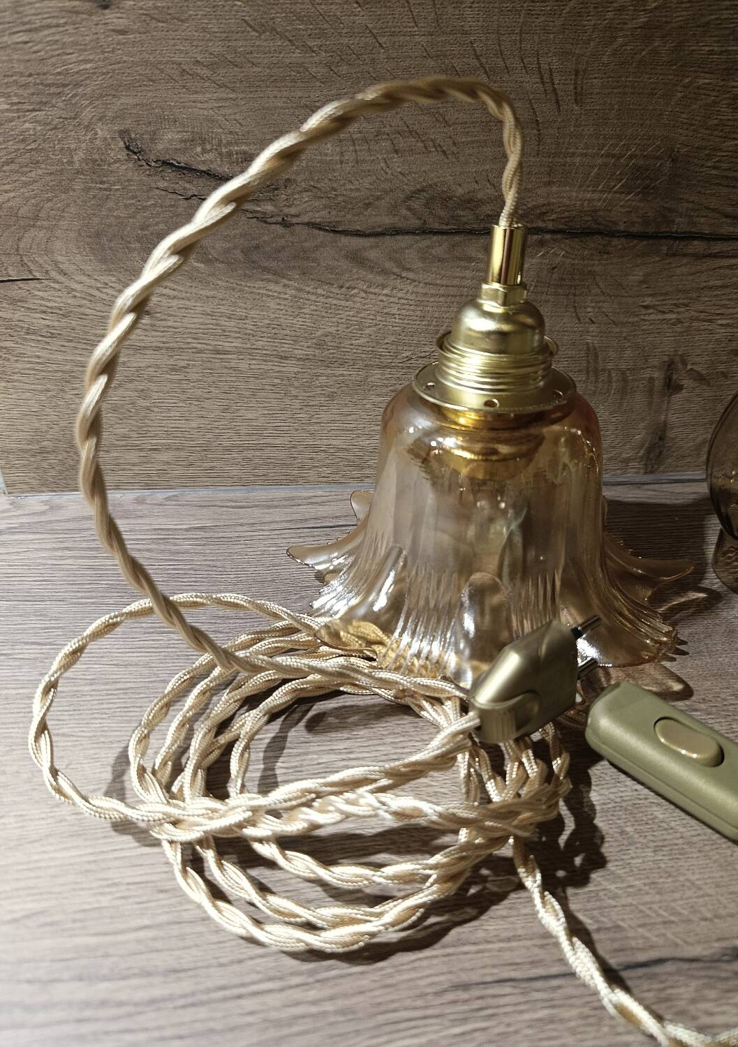 Amber tulip glass portable lamp, golden braided cord.