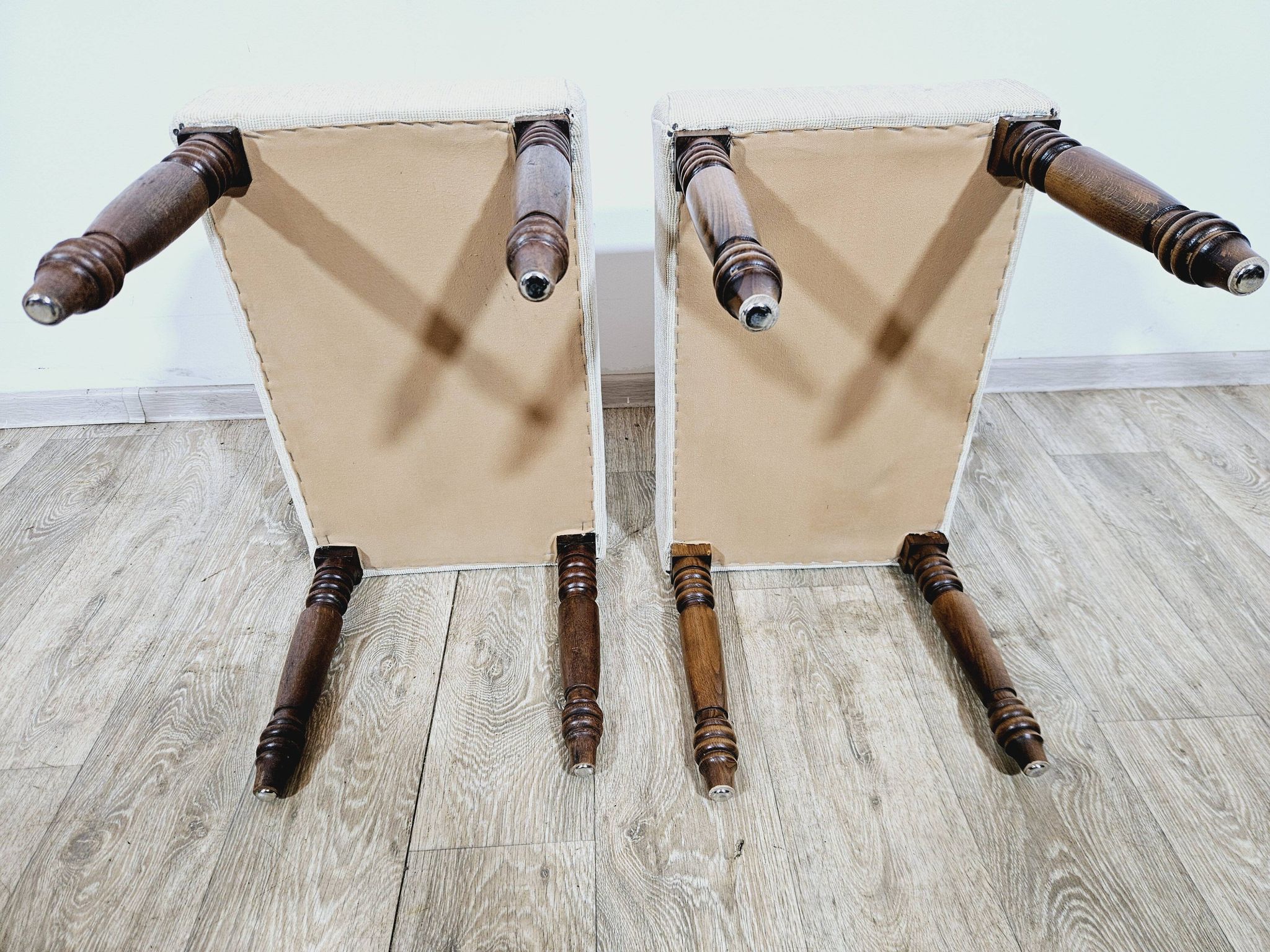 A pair of English upholstered pouffes/footstools from the 19th century