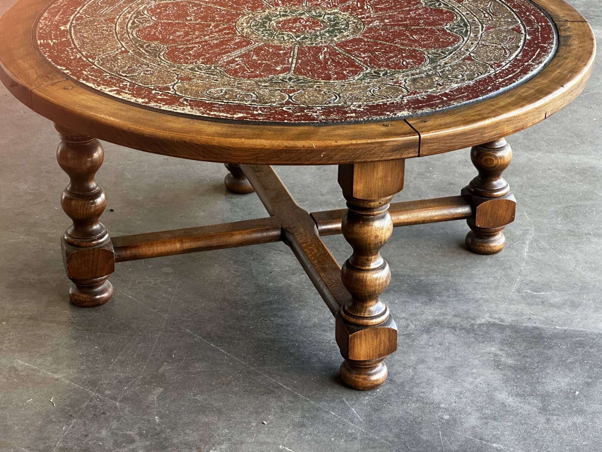 Vintage wooden turned coffee table with leather and astrological decoration.