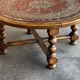 Vintage coffee table in turned wood and leather with astrological decoration.