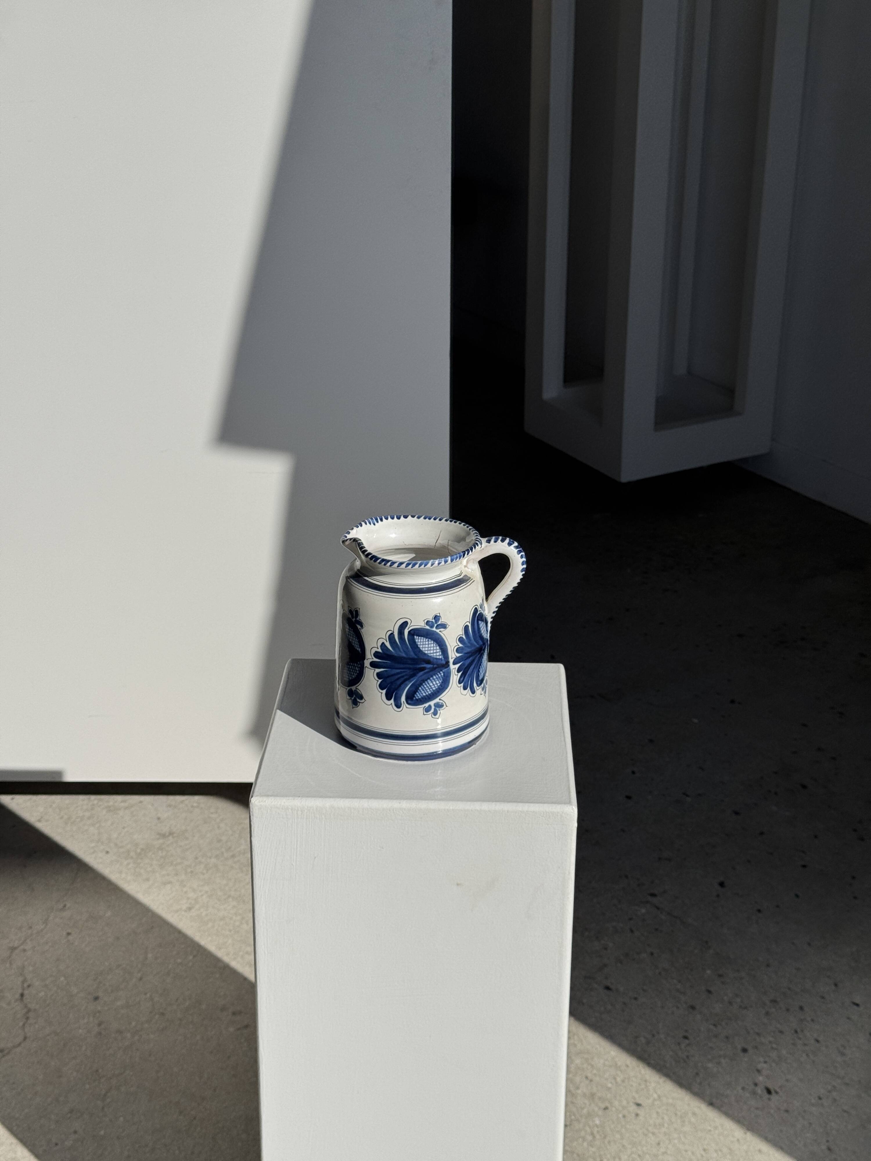 Artisan blue floral decorative carafe, height 17 cm, diameter 24.5 cm.