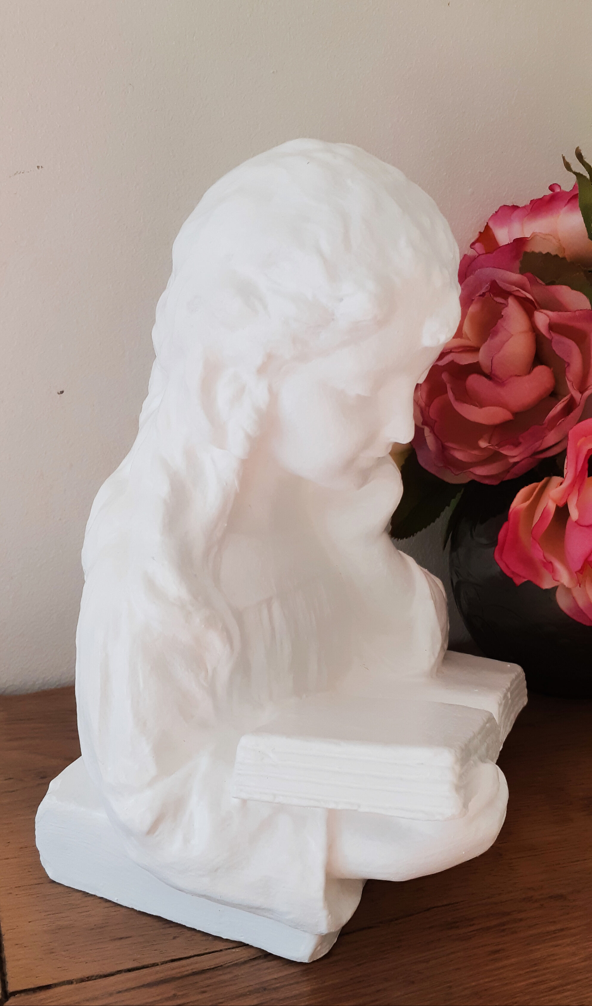 Plaster bust reading child