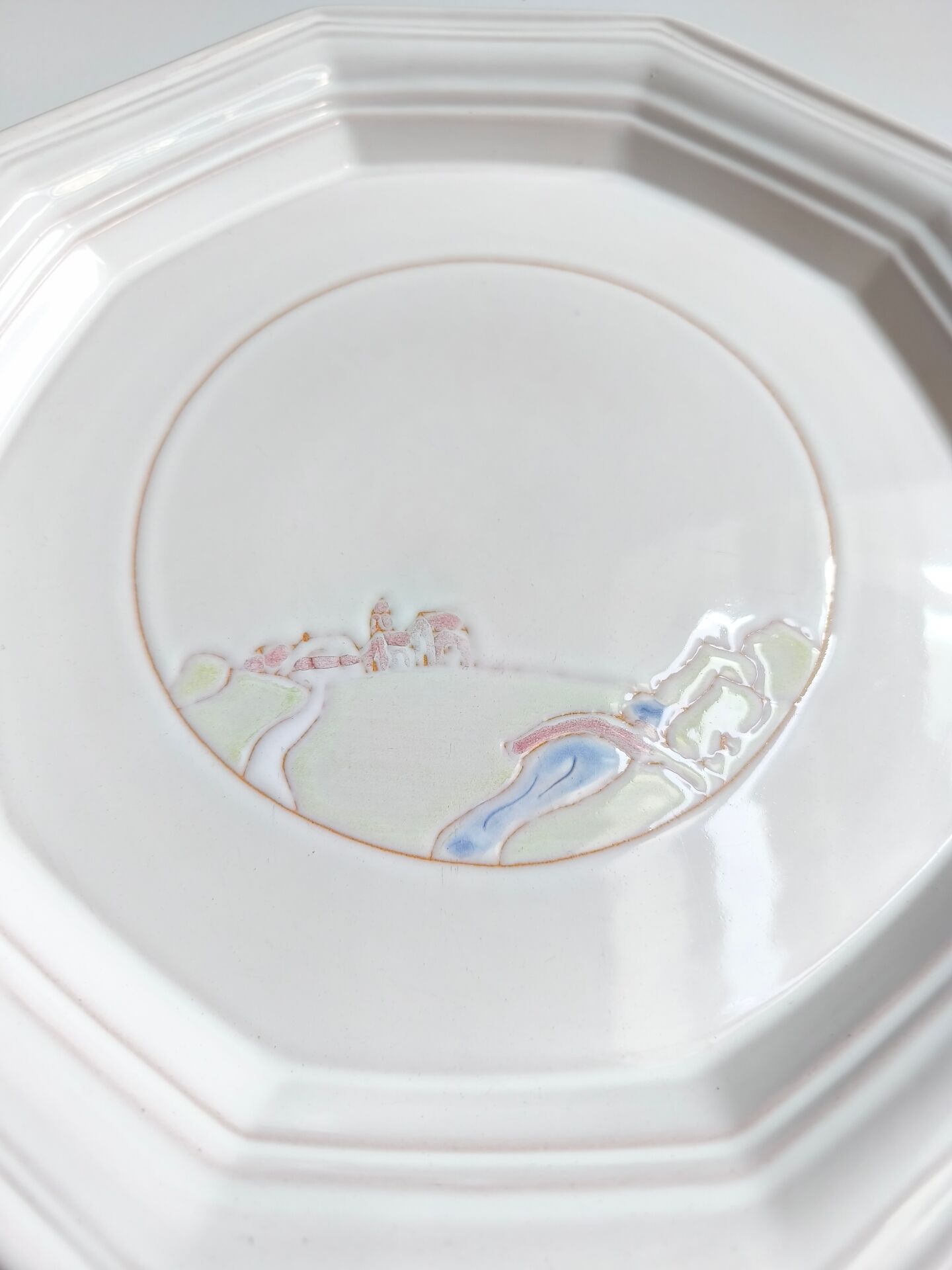 Round vintage Niderviller plate with a country decor.