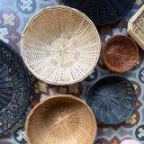 Set of 7 black and natural wicker baskets.