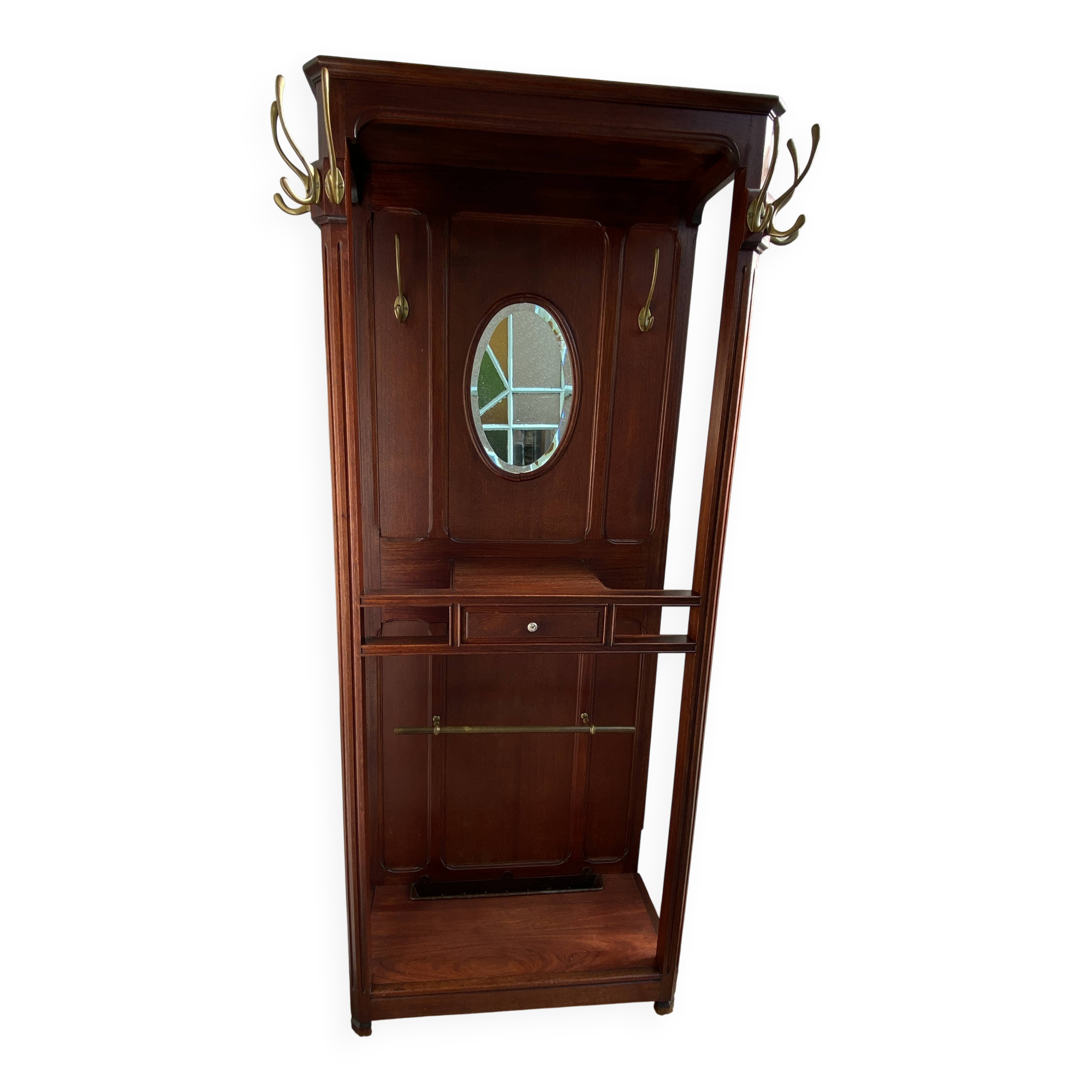 Antique wooden coat rack with mirror and shelf.