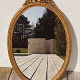 Authentic chic vintage oval mirror, in gilded wood, in baroque style.