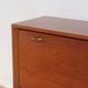Vintage teak bar cabinet with black glass interior.