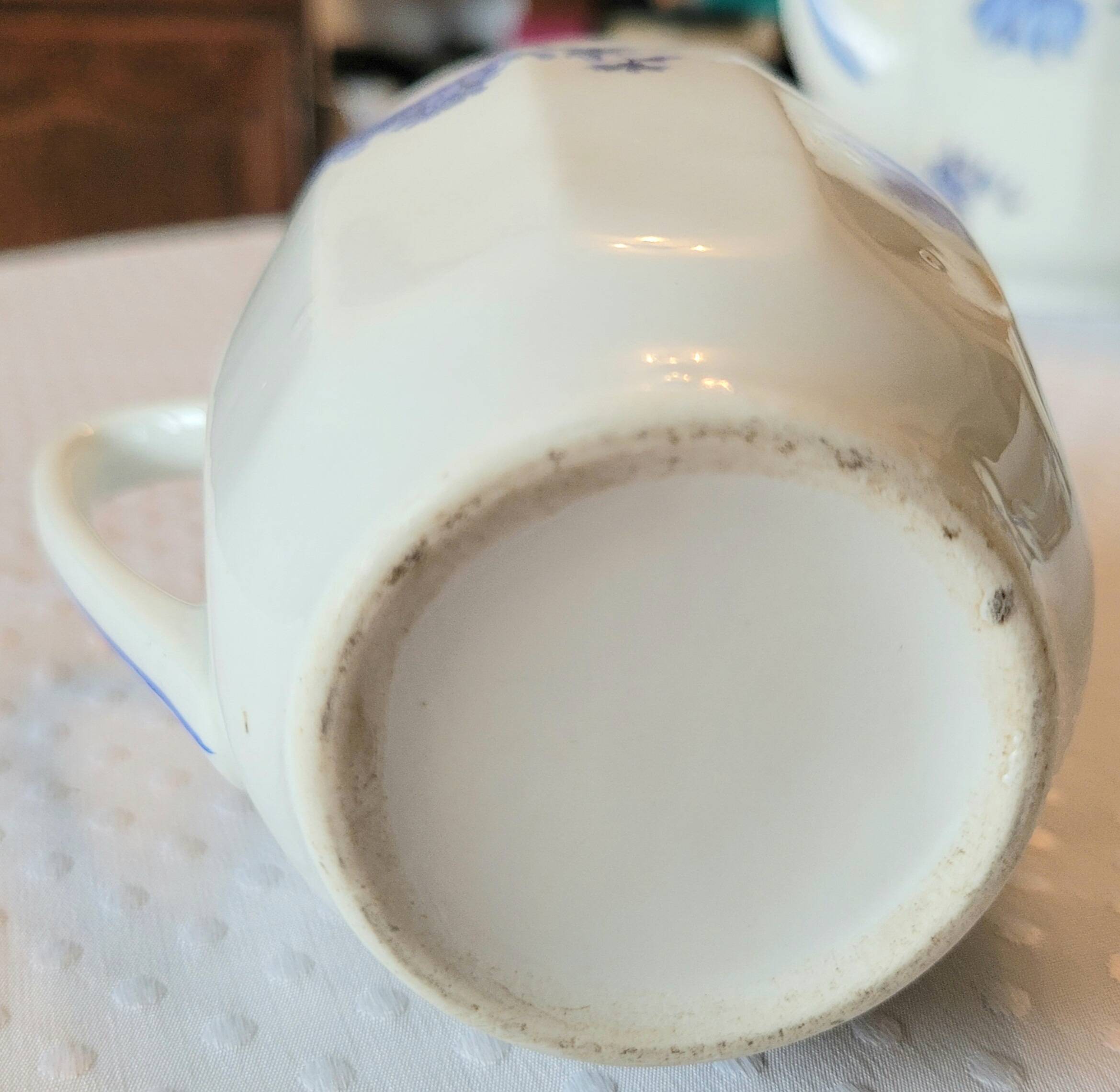 Blue and white ceramic coffee service with flowers.