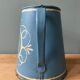 Old painted sheet metal jug or milk jug
