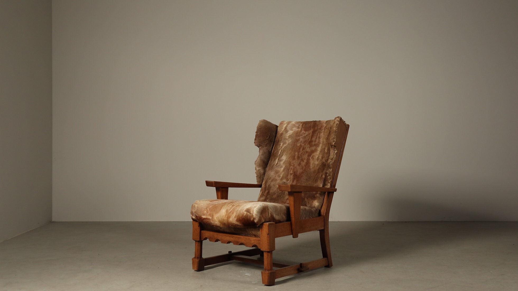 Brutalist oak lounge chair and ottoman in original goat hide, 1960s