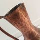 Pitcher-shaped vase in hammered copper