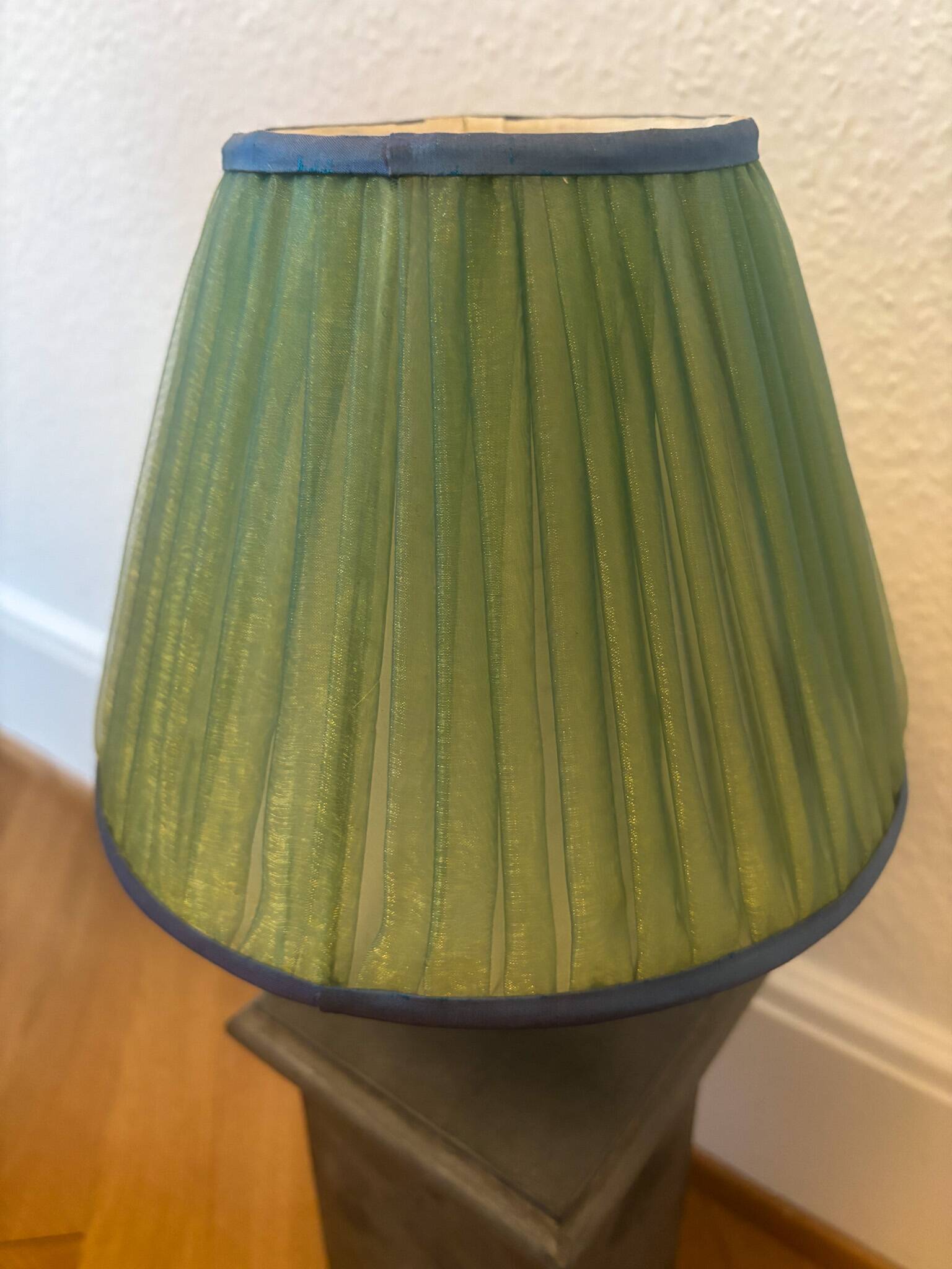 Vintage stone lamp with green pleated shade.