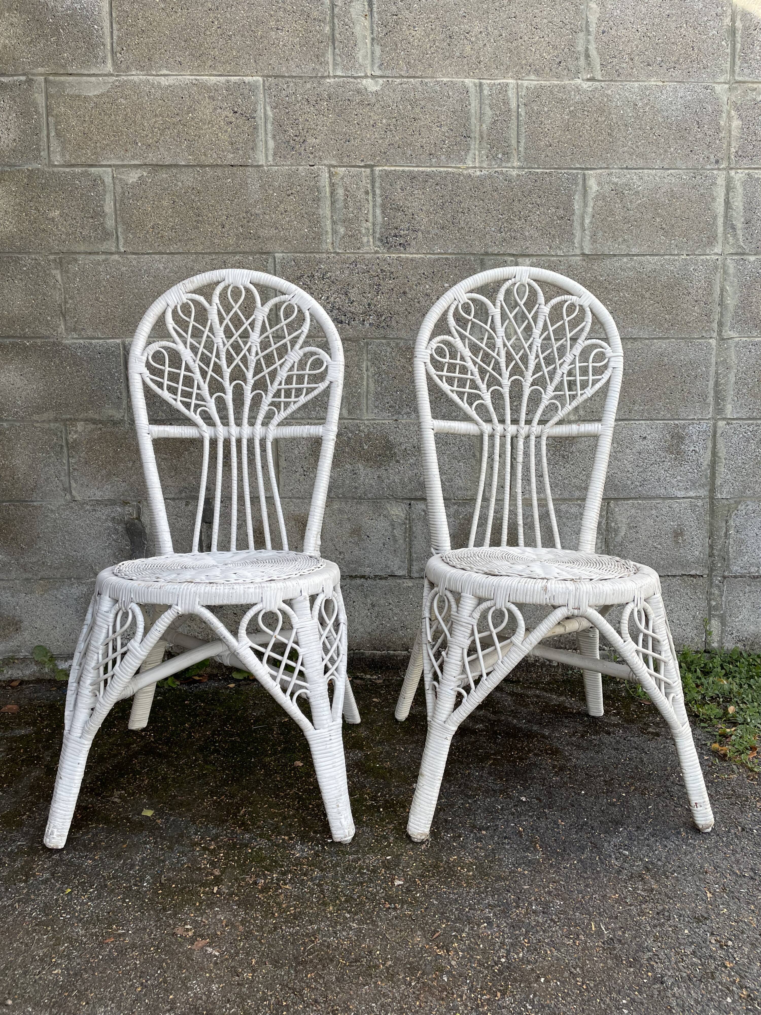 Pair of white peacock rattan chairs, circa 1960