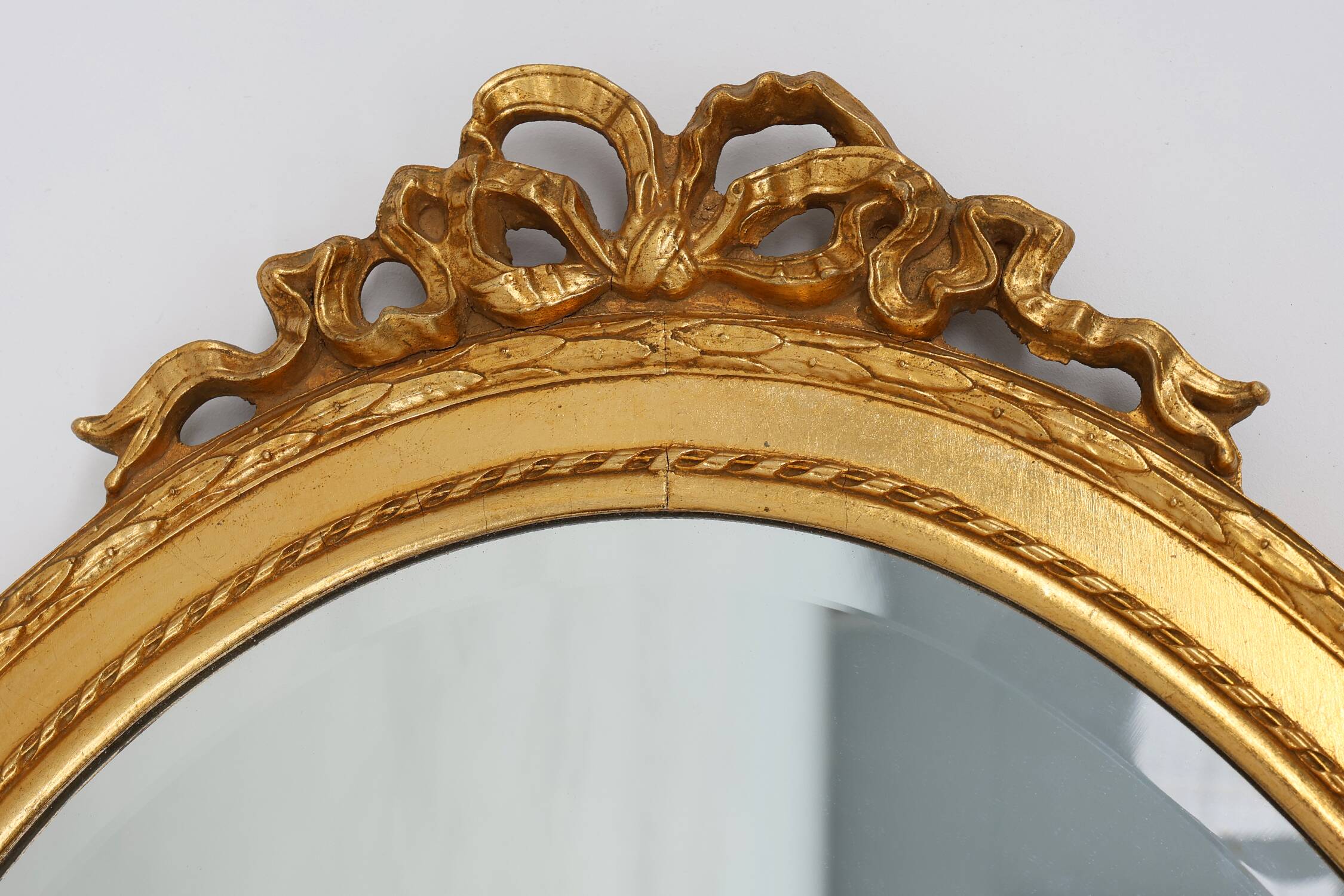 Oval shaped carved gilded Baroque mirror with beveled glass, Belgium