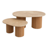 Oval coffee table duo travertine and raw fluted wooden legs.