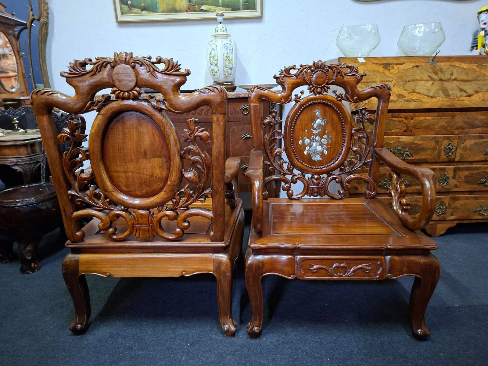 Pair of Asian armchairs in carved wood with mother-of-pearl inlays.