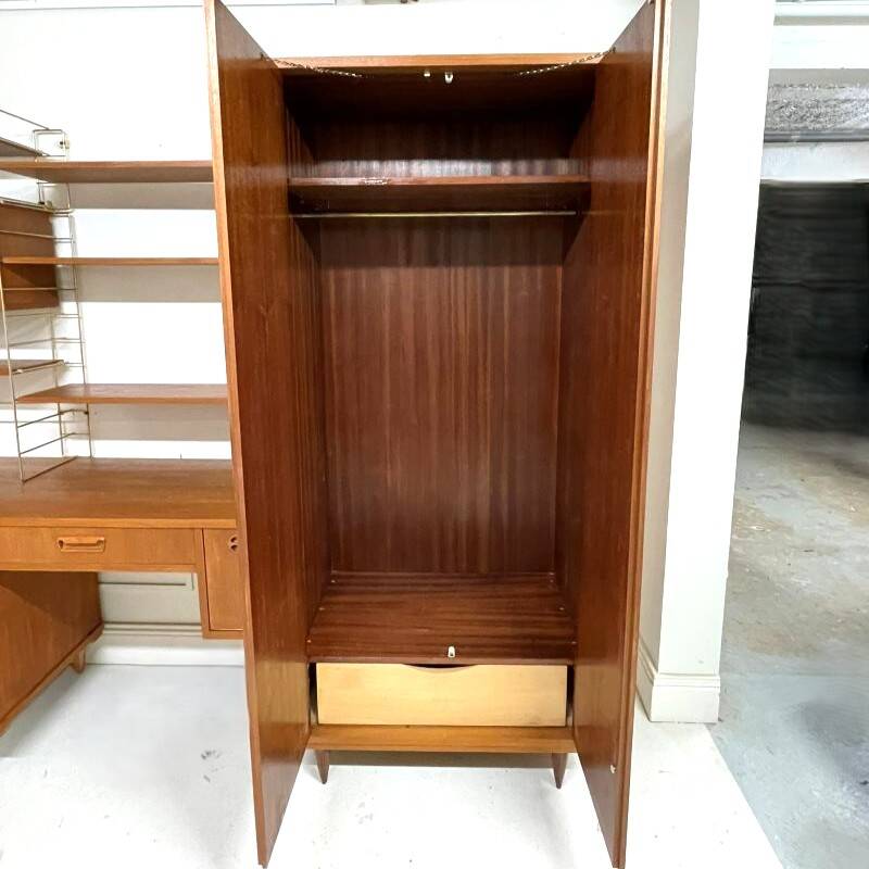A piece of furniture combining a desk, wardrobe, and shelves.