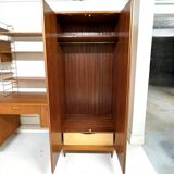 A piece of furniture combining a desk, wardrobe, and shelves.