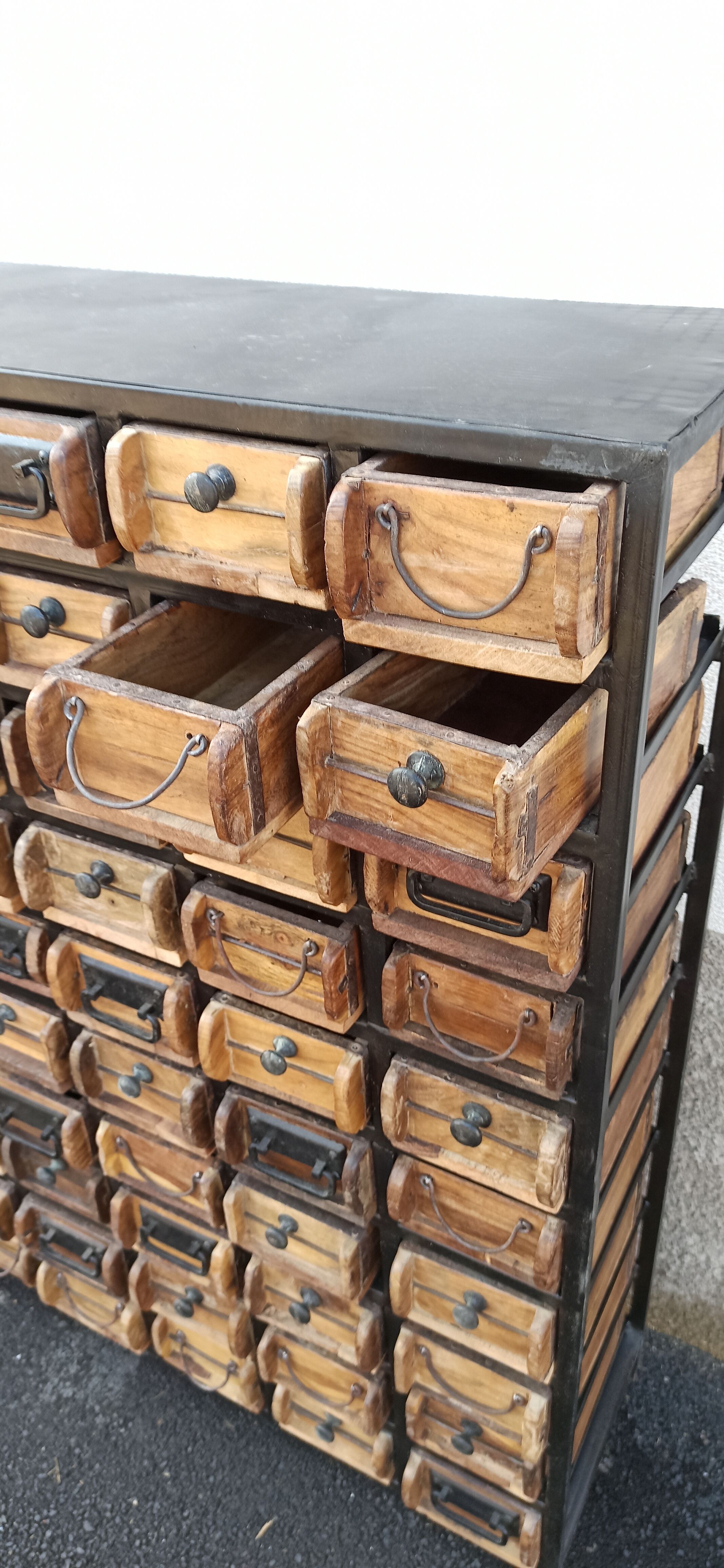 Black metal storage cabinet with 60 wooden drawers