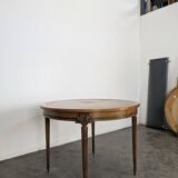 Louis XVI style dining table with a leather top.