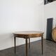 Louis XVI style dining table with a leather top.