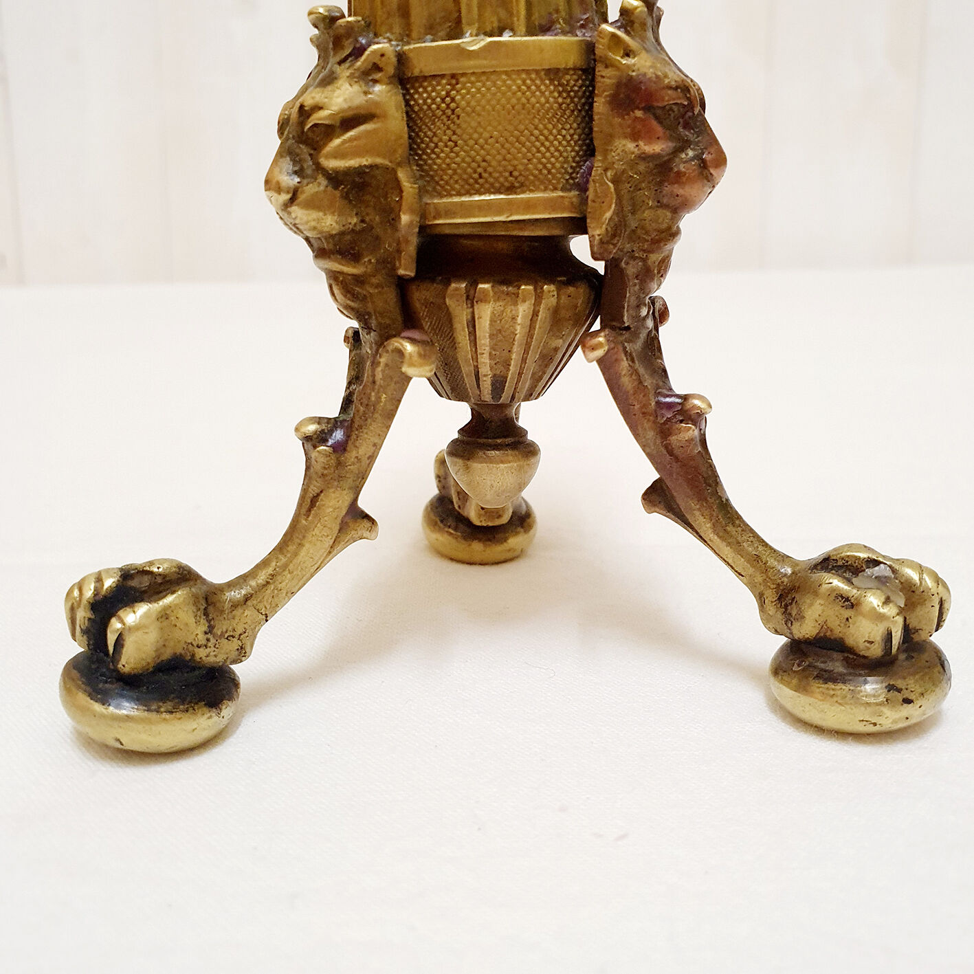 Golden candle holder with lion's head and legs